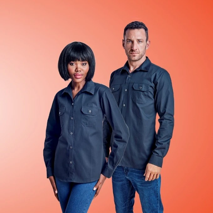 A hand holding a stack of neatly folded, plain, multi-colour T-shirts, ideal for customisation into branded T-shirts.